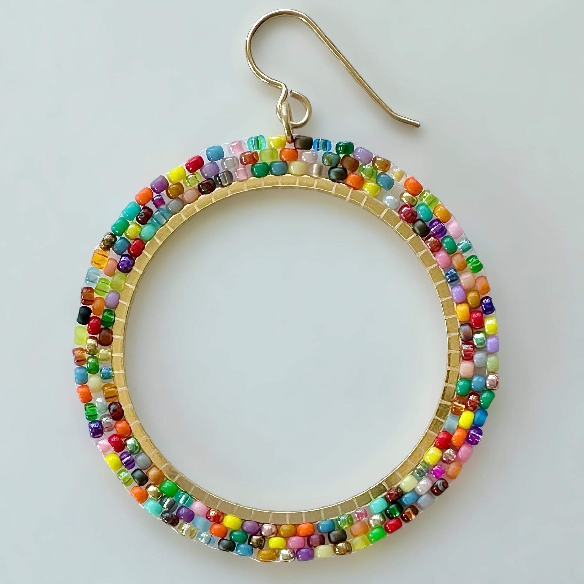 A beaded hoop earring made with multicolor Miyuki 11/0 seed beads by The Bead Mix